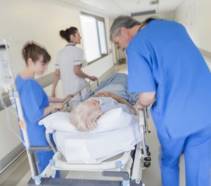 Healthcare team caring for patient on a guerney