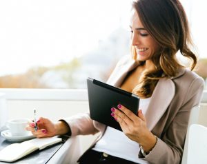 Business woman using mobile device to apply for financing